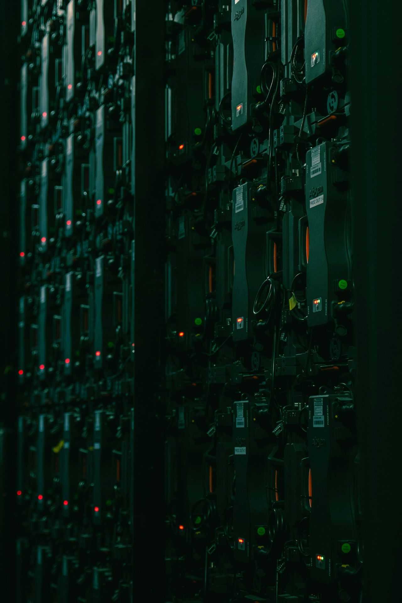 Large array of equipment cabinets in a dim hall